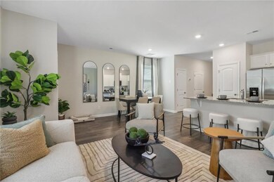 Living room featuring dark wood-type flooring, recessed lighting, and baseboards