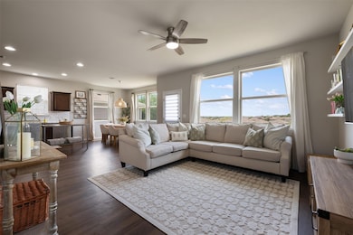 Living area featuring a ceiling fan, recessed lig