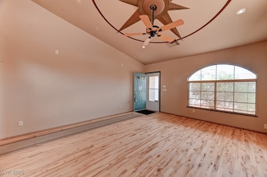 Spare room with ceiling fan, light wood-style floo