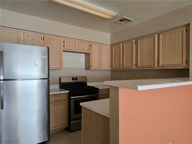 Kitchen with stainless steel appliances, light bro