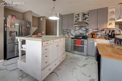 Kitchen with marble finish floor, gray cabinets, w