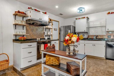 Kitchen with stainless steel fridge, sink, electri