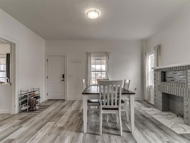 Dining area featuring a brick fireplace and light 