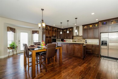 Amazing Kitchen with Wood Flooring and On-Trend Stacked Cabinets