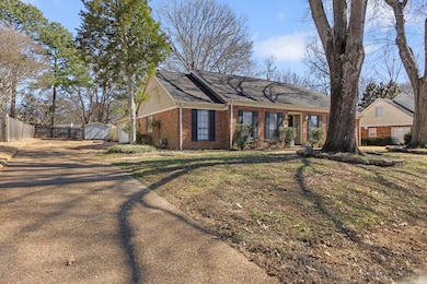 Single story home with a garage, a front yard, bri