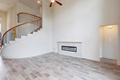 Unfurnished living room with a towering ceiling an