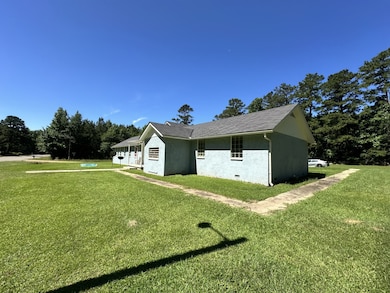 View of side of property with a lawn and stucco siding