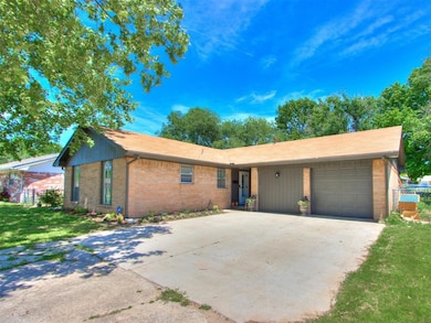 Ranch-style home with a garage, concrete driveway,