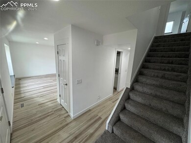Stairs featuring baseboards, visible vents, and wo