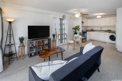 Living room, dining room, and kitchen in background.