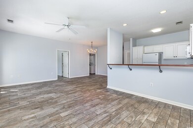 Kitchen with white cabinets, white appliances, woo