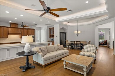Living room with ceiling fan with notable chandeli