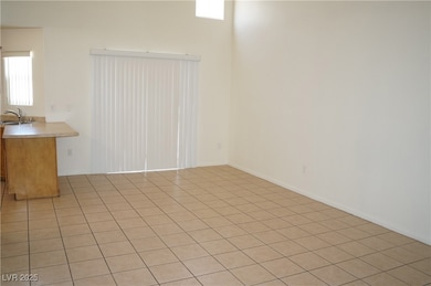 Empty room featuring light tile patterned flooring and a sink