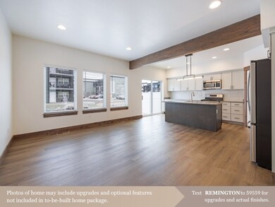 Kitchen with appliances with stainless steel finishes, plenty of natural light, recessed lighting, white cabinetry, and beam ceiling
