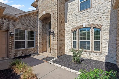 I absolutely love this welcoming front porch set up.  Welcome your guests right in amongst the charming flower beds.  Note the separate entrance to the 3rd garage bay.