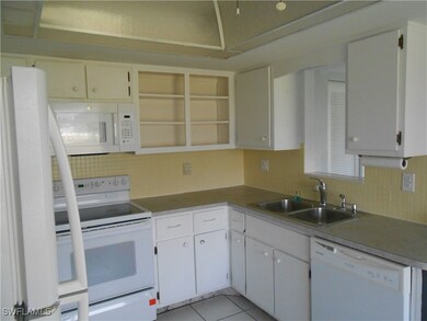 Kitchen featuring white appliances, light tile pat