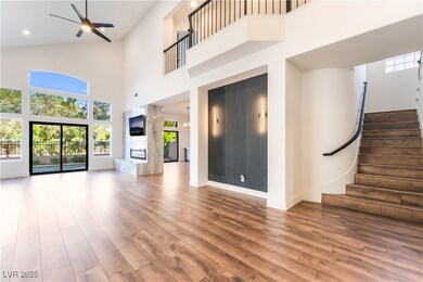Unfurnished living room featuring a towering ceili