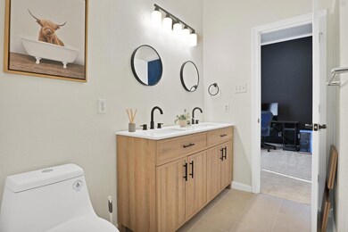 Bathroom with tile patterned flooring, double vani