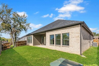 Rear view of house with a patio area, a fenced backyard, brick siding, and a shingled roof