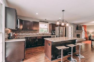 Stainless steel appliances, tile backsplash and a convenient island with bar seating.