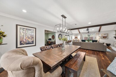 Features include crown moulding, recessed lighting, chandelier lighting & laminate wood floors.