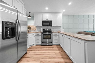Kitchen featuring kitchen peninsula, stainless ste
