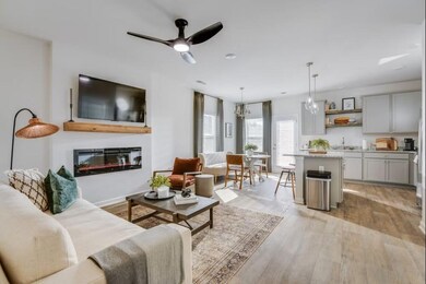 Living room featuring light wood-style floors, cei