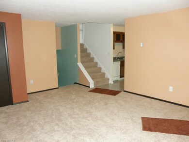 View from living room into kitchen, upstairs to be