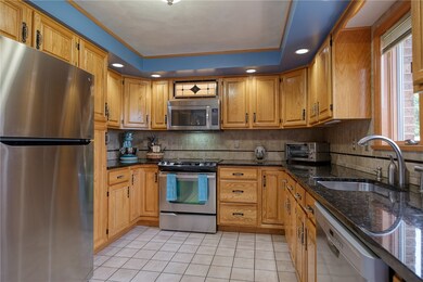 The kitchen boasts solid oak cabinets, granite cou