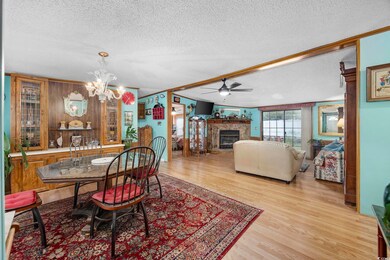 Dining area with ceiling fan with notable chandeli