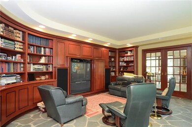 The dining room/library includes curved built-in c