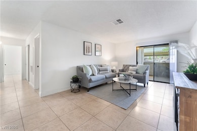 Living area featuring visible vents, baseboards, a