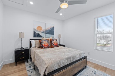 Bedroom featuring light wood-style flooring, base