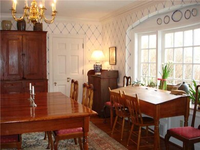 Dining Room. hardwood floor, bay window, door to s