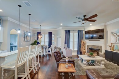 Living room featuring ornamental molding, dark woo