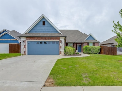 View of front facade with roof with shingles, driveway, an attached garage, and brick siding