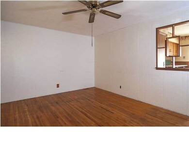 Living room with hardwood flooring and ceiling fan