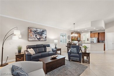Tiled living room featuring ornamental molding and
