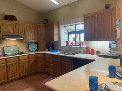 Kitchen featuring black appliances, backsplash, va