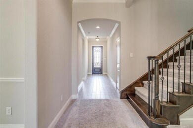Entrance foyer with ornamental molding and wood-type flooring
