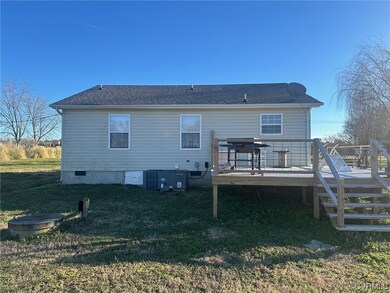 Rear view of house featuring a yard, a deck, and c