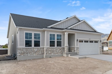 Craftsman-style home with stone siding, an attached garage, board and batten siding, concrete driveway, and a shingled roof