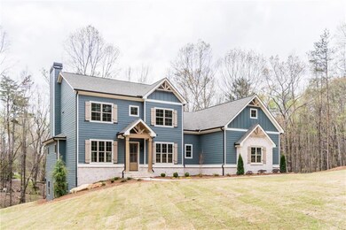 View of front of home featuring a front yard, bric