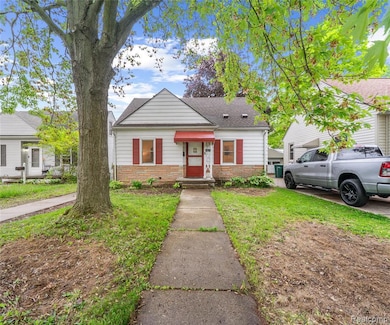 Bungalow-style home with a front yard, stone siding, and a shingled roof