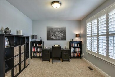 Spacious office or formal living room with glass french doors.