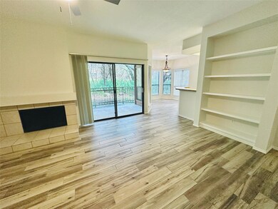 Unfurnished living room with wood finished floors, built in features, and ceiling fan