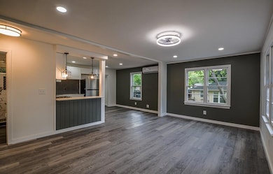 Unfurnished living room with a wall mounted air co