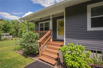 View of exterior entry featuring covered porch and