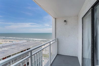 Balcony with view of water and beach
