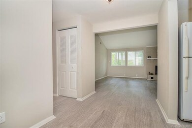 Foyer is open to the kitchen, a hallway to the left leads you to the bedrooms, and the living room is straight ahead.